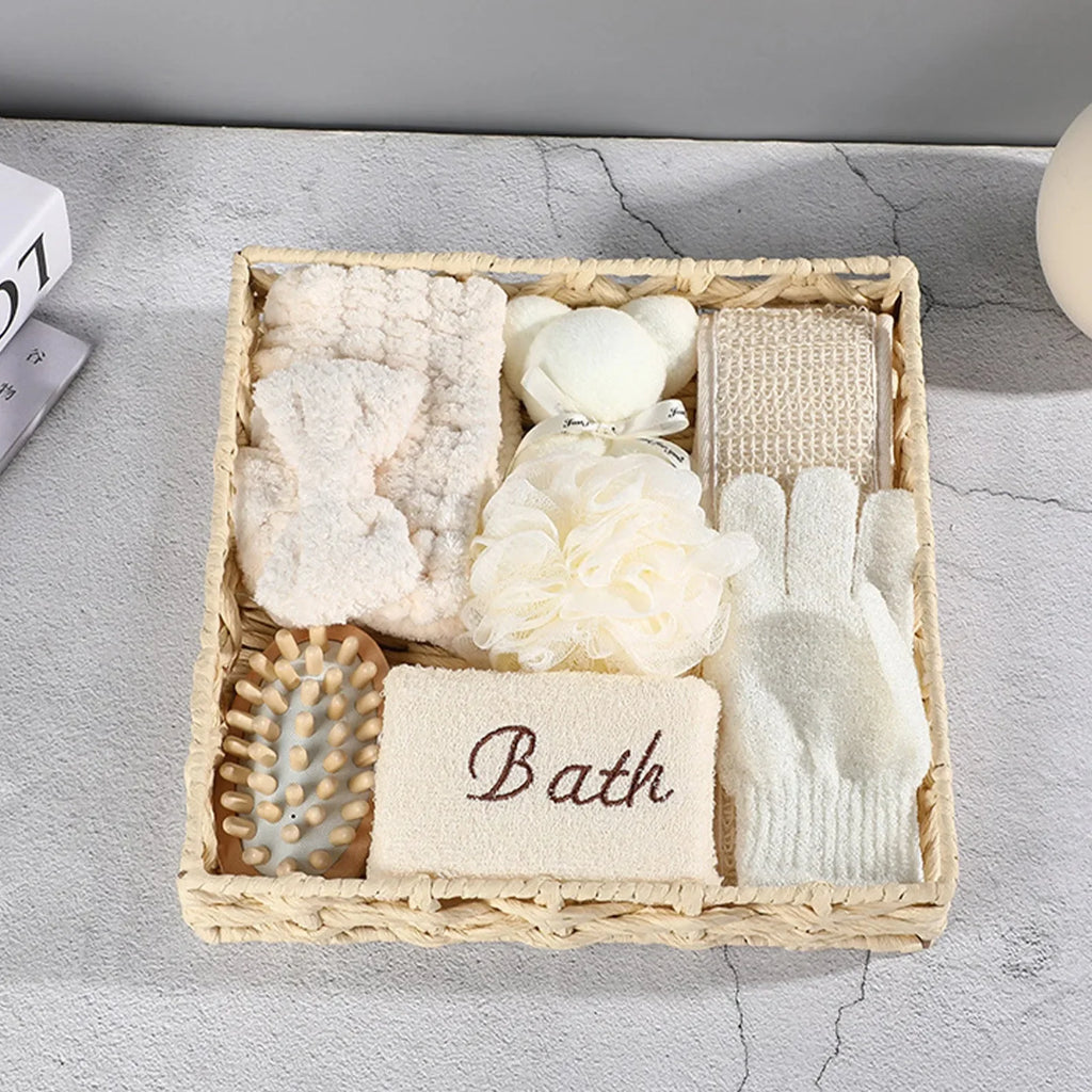 Natural bath gift set with sponge, loofah, gloves, brush, and headband in a woven basket